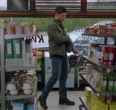 a man is shopping in a grocery store