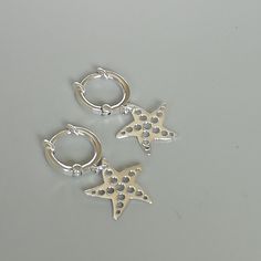 IMPORTANT **Please go through all the pictures i have posted for a listing with a ruler, on a model, on my hand, to get an exact idea of the actual size of the item. A PAIR of 12 mm sterling silver hoops. Comes with star fish charm. Dimensions: Hoops: 12 x 2 mm Shell: 14 x 14 mm Weight: 2.4 gm These earrings are made of 925 hypoallergenic sterling silver. All my pieces are sent in a gift box. I can include a personal message from you if needed. You are welcome to contact me at... bhavnakwintra19 Silver Earrings With Starfish Charm As Gift, Starfish Hoop Earrings As Gift, Silver Hoop Earrings With Star Charm As Gift, Starfish Charm Hoop Earrings As Gift, Silver Starfish Charm Earrings For Beach, Silver Hoop Earrings With Star Charm, Silver Sterling Silver Starfish Charm Earrings, Silver Jews, Wanderlust Jewelry