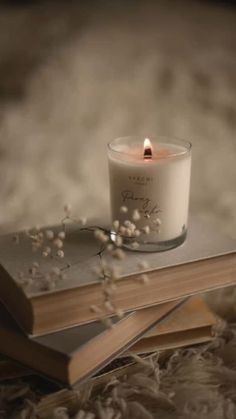 a candle sitting on top of two books