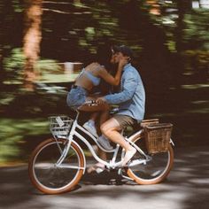 a man riding on the back of a bike while holding a woman's head