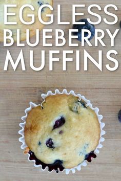 an eggless blueberry muffin is shown on a wooden surface with the words, eggless blueberry muffins