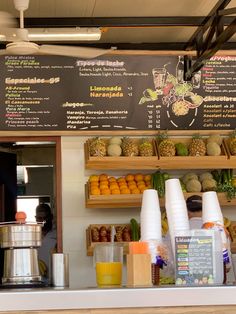 a menu on the side of a restaurant with fruits and vegetables in front of it