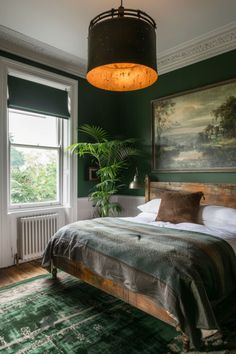 a bed sitting in a bedroom next to a window with a painting on the wall