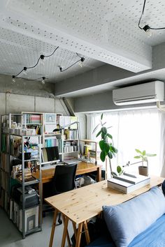 a living room filled with furniture and bookshelves