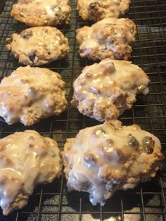 six cookies with icing sitting on a cooling rack