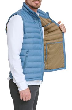 A quilted stand collar and lightweight fill insulate this heat-keeping puffer vest. 26 1/2" length (size Medium) Stand collar Front zip closure Front zip pockets Water resistant 100% nylon Machine wash, tumble dry Imported Functional Nylon Vest With Zipper Closure, Outdoor Nylon Vest With Zipper Closure, Functional Blue Nylon Puffer Jacket, Functional Blue Outerwear For Travel, Functional Spring Puffer Jacket For Outdoor Activities, Spring Functional Puffer Jacket For Outdoor Activities, Functional Blue Outerwear With Zipper Closure, Travel Nylon Puffer Jacket With Pockets, Functional Nylon Puffer Jacket For Spring