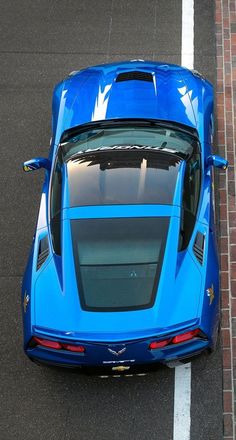 a blue sports car is parked on the street