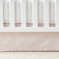 a baby crib with pink and white stars on it