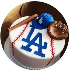 a birthday cake decorated with a baseball, glove, and hat on top of it