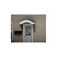 a house with a white front door and an awning on the side of it