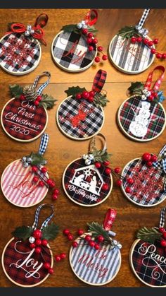 christmas ornament ornaments are hanging on a table with red and black plaid ribbon