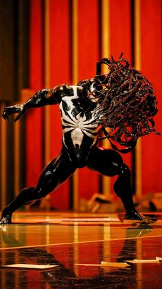 a black and white spider - man action figure on a stage