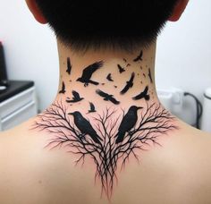 the back of a woman's neck with birds on it