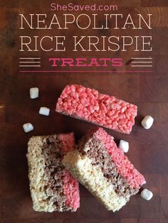 three pieces of rice krispy treats on top of a wooden table with marshmallows