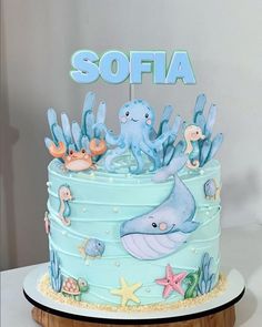 there is a blue cake decorated with an octopus and sea animals on it that says sofia