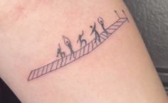 a woman's arm with a line drawing of people walking up and down the stairs