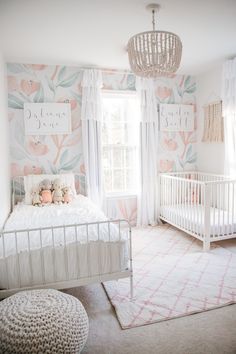 a baby's room with floral wallpaper and a crib in the corner