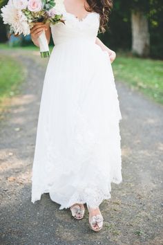 a woman in a white dress holding a bouquet