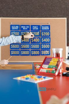 a man is pointing at a board with $ 20, 000 on it in front of him