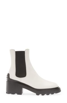 This elevated take on the Chelsea boot is distinguished by a block heel and lugged sole with pebbled tread inspired by the brand's driving shoes. 2 1/4" (57mm) heel (size 38.5) 6" shaft Pull-on style with elastic gore insets Leather and textile upper and lining/rubber sole Made in Italy Women's Designer Shoes Luxury Fall Platform Boots With Lug Sole, Calf Leather Boots With Lug Sole For Work, Modern Boots With Lug Sole And Medium Width, Luxury Lug Sole Boots For Work, Luxury Lug Sole Boots For Workwear, Modern Ankle Boots With Lug Sole, Modern White Boots With Lug Sole, Calf Leather Platform Boots With Lug Sole For Work, Casual Calf Leather Heeled Boots With Reinforced Heel