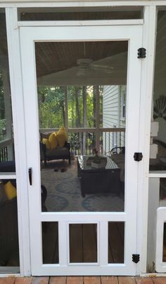 the front door to a house with glass panels and doors on each side, facing an outdoor patio