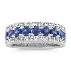 This 14-karat white gold band features traditional blue natural sapphires along the center with sparkling natural diamond borders. It offers a beautiful  bold look  making a gorgeous anniversary gift  wedding band  or daily accessory. Classic Sapphire Ring With Pave Setting, Classic Sapphire Rings With Pave Setting, Classic Blue Rings With Pave Setting, Sapphire Diamond Ring With Pave Setting In White Gold, White Gold Sapphire Diamond Ring With Pave Setting, Sapphire Rings With Pave Setting, Round Cut, Diamond Sapphire Ring With Pave Setting, Sapphire Ring With Diamond Pave Setting, Classic Sapphire Ring With Pave Setting For Anniversary