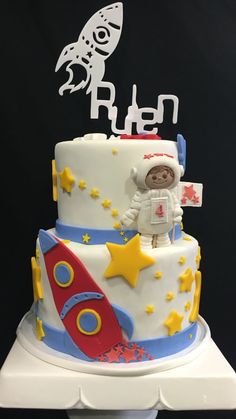 a birthday cake with an astronaut on top