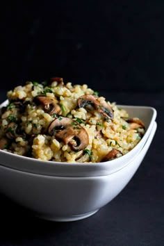 a white bowl filled with rice and mushrooms