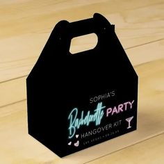 a black party bag with neon lights on the front and sides, sitting on a wooden table