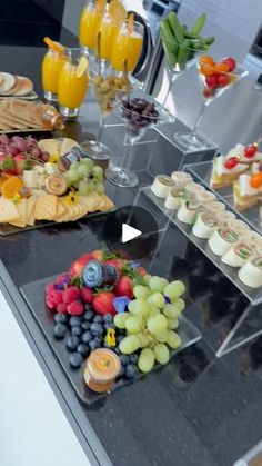 a table topped with lots of trays of food and drinks on top of it