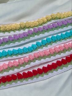 multicolored crocheted ribbon laying on top of each other