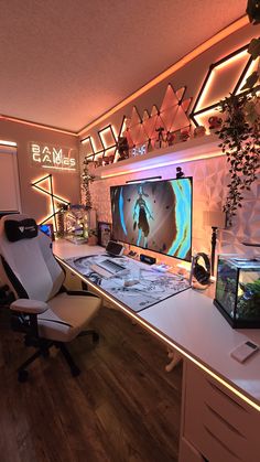 a room with a desk, computer monitor and fish tank in front of the screen