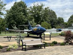 an airplane sitting on top of a park bench