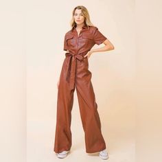 Vegan Leather Brown Leather Jumpsuit. Utility Style With Wide Legs. Never Worn. Brown Jumpsuits And Rompers For Fall, Chic Brown Jumpsuits And Rompers For Spring, Brown Short Sleeve Jumpsuits For Work, Trendy Brown Jumpsuits And Rompers With Pockets, Trendy Belted Jumpsuits And Rompers For Fall, Fitted Faux Leather Jumpsuits And Rompers For Fall, Fitted Faux Leather Jumpsuits For Fall, Trendy Belted Jumpsuit For Fall, Trendy Brown Jumpsuits And Rompers For Spring