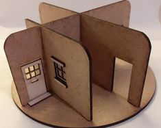 a paper cut out of a house with a door and window