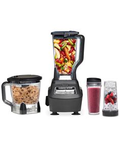 three blenders with different types of food in them and one being filled with fruit