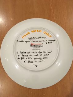 a white plate with writing on it that says hand wash only