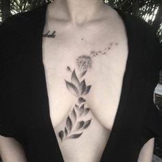 a woman's chest with a flower tattoo on it