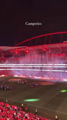 fireworks are lit up in the stadium as fans watch