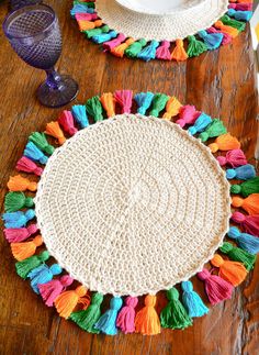 the table is decorated with colorful tassels and placemats on top of it