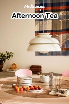 a dining room table with plates, bowls and cups on it in front of a painting