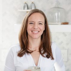 a woman holding a glass in her hands