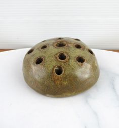 a ceramic object sitting on top of a white table