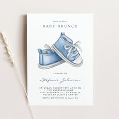 a blue shoe baby shower is on the table next to a toothbrush and paper