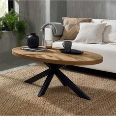 a coffee table sitting on top of a rug next to a couch