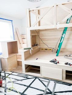 a room that has been built with wood and some tools on the floor in front of it