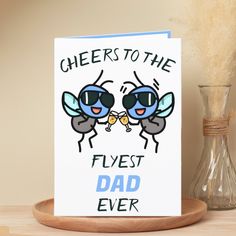 a greeting card featuring two bees with sunglasses saying cheers to the flyst dad ever