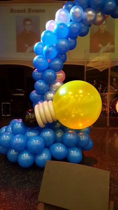 blue and yellow balloons are on display in a museum