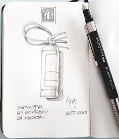 an open notebook with a pen on top of it and a drawing of a bottle