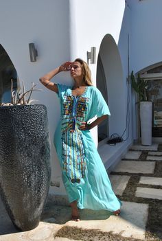 This embroidered cotton Kaftan is a summer breeze! Made extremely breezy and light weight, this Kaftan is great for those hot summer days. You will feel like you're practically wearing nothing. The intricateness, color combination, and beauty of the embroidery is a show stopper and will surely grab everyone's attention. It is the perfect dress for the summer. This Kaftan is ideal to wear for any casual occasion. Whether taking a trip down the shopping lane, or home-based kitty parties, parties, Beach Kaftan With Embroidery And Short Sleeves, Embroidered Short Sleeve Kaftan For Beach, Beach Embroidered Short Sleeve Kaftan, Long Embroidered Kaftan For Beach Season, Beach Dress With Floral Embroidery, Embroidered Long Kaftan Beachwear, Embroidered Maxi Kaftan For Beachwear, Embroidered Maxi Length Kaftan For Beachwear, Green Floral Embroidered Kaftan For Summer